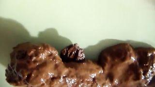 Shaved asshole in close up while pooping