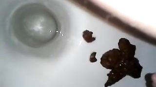 Shaved wife pooping a big one in toilet