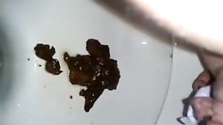 Shaved wife pooping a big one in toilet