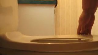 Fat granny pooping over toilet