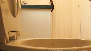 Fat granny pooping over toilet