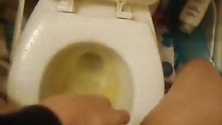 Hot girl peeing over toilet