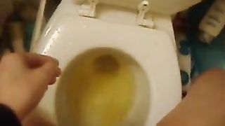 Hot girl peeing over toilet