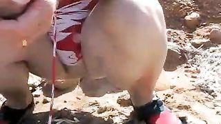 Mature lady peeing on the ground outdoor