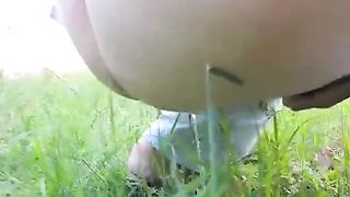Chubby girl peeing in her back yard