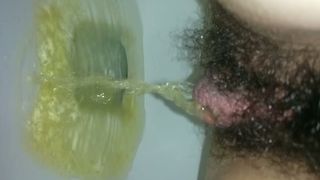 Hairy girl peeing in very close up