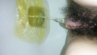 Hairy girl peeing in very close up