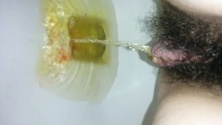 Hairy girl peeing in very close up