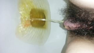 Hairy girl peeing in very close up