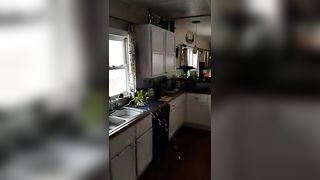 Tattooed milf peeing in kitchen