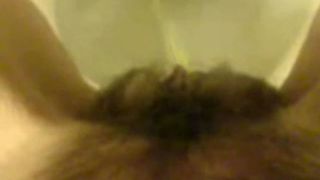 Girl with hairy pussy peeing