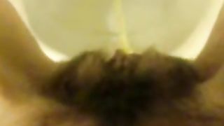 Girl with hairy pussy peeing