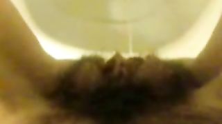 Girl with hairy pussy peeing