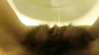 Girl with hairy pussy peeing