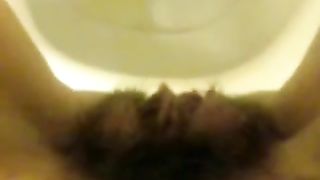 Girl with hairy pussy peeing