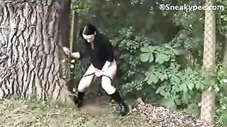 Beautiful brunette peeing in public place