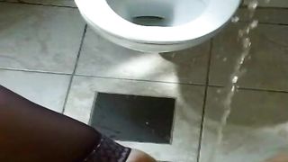 Naughty girl peeing in toilet