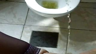 Naughty girl peeing in toilet