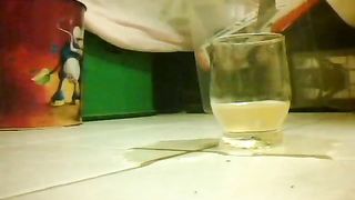 Girl peeing in a glass