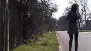 Bianca peeing behind a fence