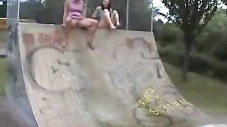 Two rocker girls peeing in a skate park