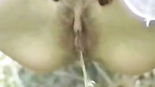 Hairy woman peeing in close up