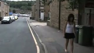 Asian babe peeing behind two houses
