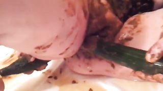 Cucumber in her ass while she smears poop