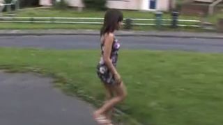 Hot brunette peeing on grass