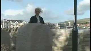 Curvy secretary peeing behind stacked hay