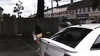 Sexy girl peeing behind parked car