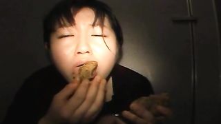 Holding a big turd in her mouth