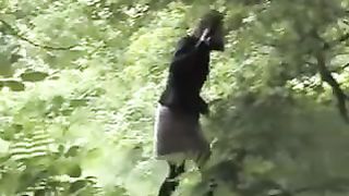 Young girl peeing in the woods