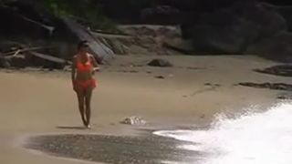 Dark haired milf peeing at beach