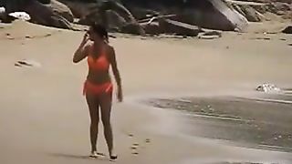 Dark haired milf peeing at beach