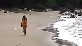 Dark haired milf peeing at beach