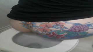 Tattooed babe shitting in toilet