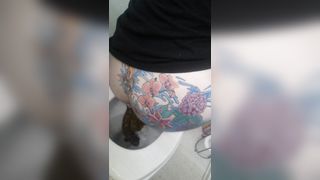 Tattooed babe shitting in toilet