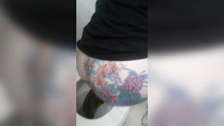 Tattooed babe shitting in toilet