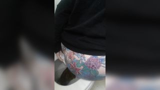 Tattooed babe shitting in toilet