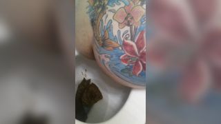 Tattooed babe shitting in toilet