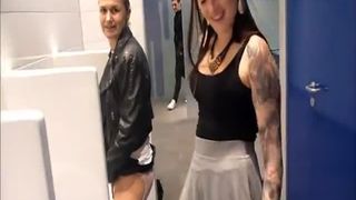 Two girls peeing together