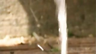 Girl with unshaved pussy peeing outdoor