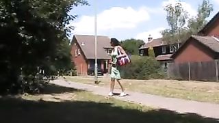 Two girls peeing behind a tree