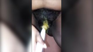 Hairy black girl smears yellow shit on her ass